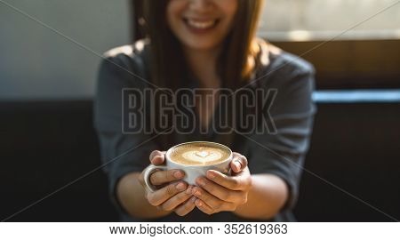 Banner Of Asian Young Female Holding A Cup Of Coffee In Modern Coffee Shop Or Coworking Space Beside