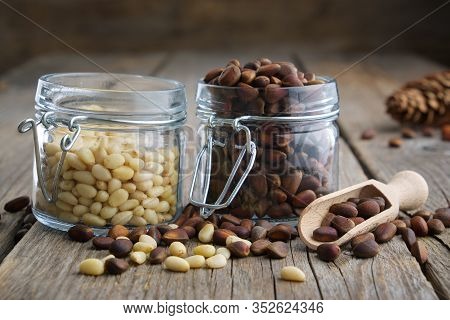 Pine Nuts. Jars Of Cedar Pine Nuts On Table.