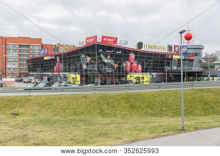 City Riga, Latvia. Supermarket Facade And Yard With Cars.