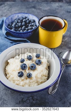 Milk Rice Porridge With Blueberry, Creamy Rice Pudding Or French Riz Au Lait In A Metal Bowl And Ena