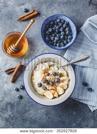 Milk Rice Porridge With Blueberry, Banana, Honey And Cinnamon, Creamy Rice Pudding Or French Riz Au 