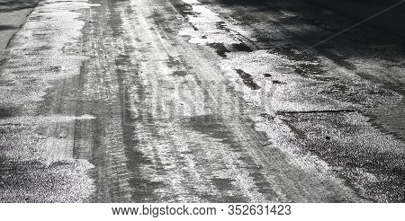 Icy Road. Selective Focus. Hazard Concept Ice-crusted Ground. Black And White Image.