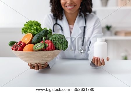 Choose Quality Healthy Food. Afro Woman Nutritionist Holding Bowl With Fresh Fruits And Vegetables A