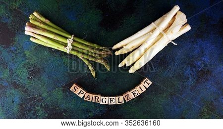 White And Green Asparagus On Background With Spargelzeit Wooden Letter.