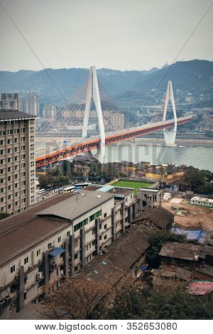 CHONGQING, CHINA â MARCH 13: Dongshuimen Bridge with urban buildings on March 13, 2018 in Chongqing. With 17M population, it is the most populous Chinese municipality.