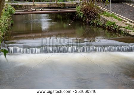 Long Exposure Of A Watefall On The River Lim Walkway At Lyme Regis In Dorset.