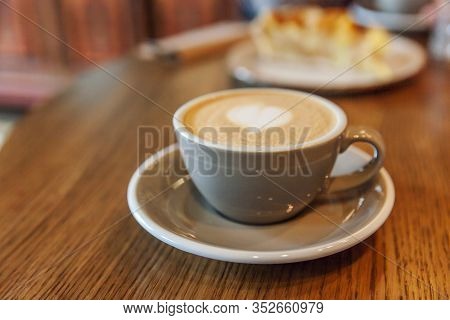 Coffee Cup Fresh Cream Organic Cappuccino On Table In Cafe. Latte Macchiato Drink In Glass Close Up.