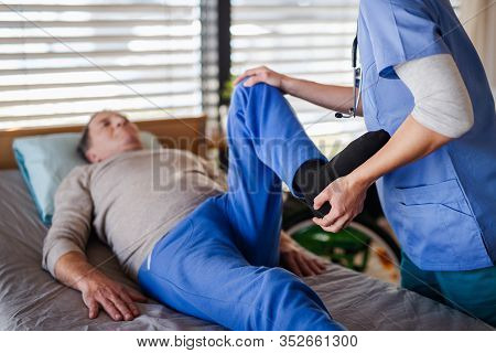 A Healthcare Worker And Senior Patient In Hospital, Physiotherapy.