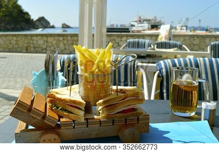 Paxos Harbour, Greece - October 01, 2017 : Paxos Harbour Club Sandwich And Chips At A Restaurant On 