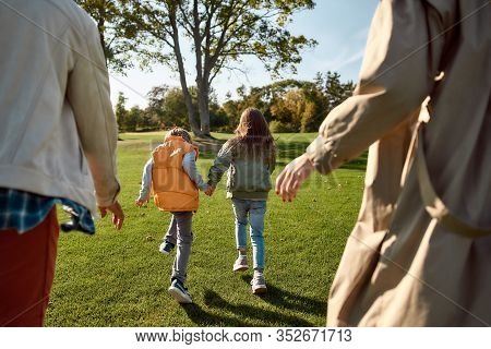 Cropped Portrait Of Happy Mother, Father, Little Boy And Girl Running And Playing Catch Game In Autu
