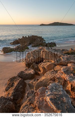 Porto Covo Beach At Sunset With Ilha Do Pessegueiro Island On The Background, In Portugal
