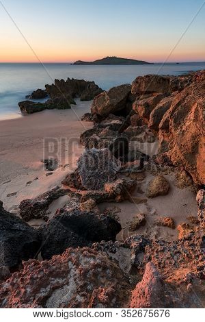 Porto Covo Beach At Sunset With Ilha Do Pessegueiro Island On The Background, In Portugal