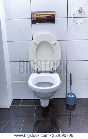 Toilet Room With Open Wall-hung Toilet Bowl