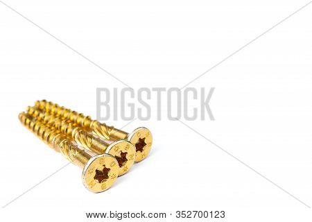 Gold Torx Screw Isolated On White. Yellow Zinc Chipboard Screw Torx, , Full Thread Close Up