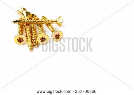 Gold Torx Screw Isolated On White. Yellow Zinc Chipboard Screw Torx, , Full Thread Close Up