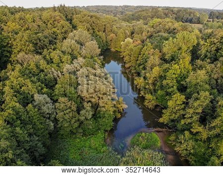 Aerial View Of Forest And Small Lake During Autumn Season And Colors. Countryside Of Walloon Brabant