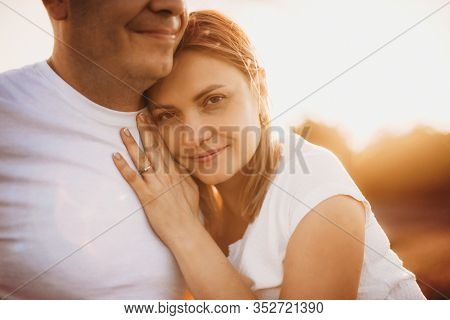 Charming Caucasian Woman With Blonde Hair Embracing Her Lover With A Lavender Field On Background