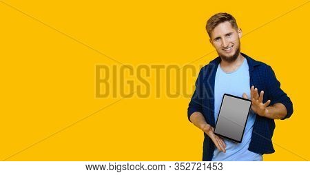 Bearded Caucasian Man With Red Hair Is Advertising Something Using A Tablet With Blank Space On A Ye