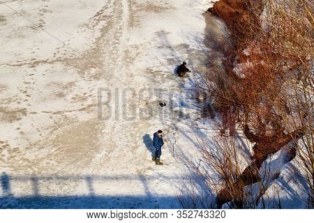 Kirov, Russia - March 23, 2019: Fisherman On The Ice Of The River On A Sunny Spring Day. Top View Of