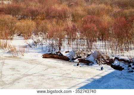 Kirov, Russia - March 23, 2019: Fisherman On The Ice Of The River On A Sunny Spring Day. Top View Of