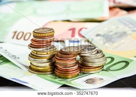 Euro Coins On Banknote Money Background, A Coin On The Background Of Stacks Of Coins And Banknotes