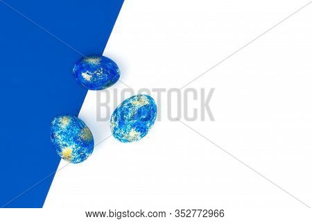Trendy Blue Easter Eggs With Golden Spots On Blue And White Background Top View With Copy Space. Han
