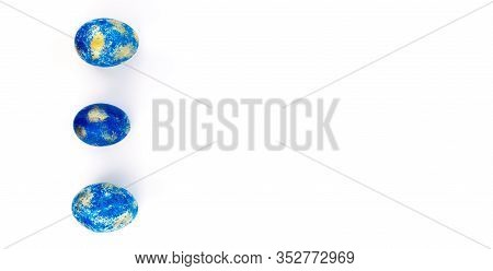 Trendy Blue Easter Eggs With Golden Spots On White Background With Copy Space. Hand Painted Spring E