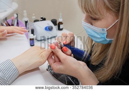The Process Of Cleaning The Nail From The Old Coating And Giving It The Desired Shape.