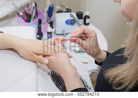 Beautician Prepares A Nail Before Applying Varnish In A Nail Salon.