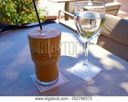 A Glass Of  Ice Coffee Cafe Frape Typical Greek Summer Dring Served With Cold Water