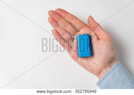Blue Pp3 Battery Lying On Womens Palm. Accumulator On White Background.