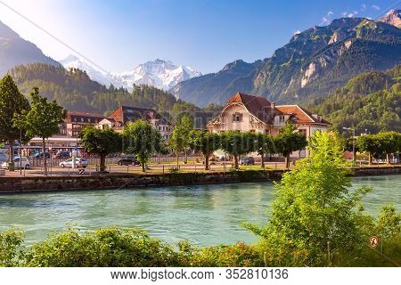 Train Station And Aare River In Interlaken, Important Tourist Center In Bernese Highlands, Switzerla