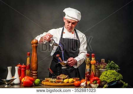 Chef Cooking Flambe Steak. Meat Is Poured On Fire. Preparation Steak With Fire.