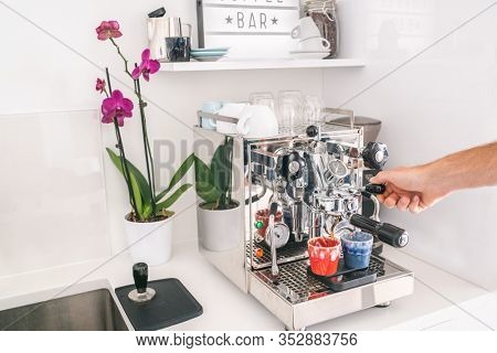 Coffee machine man barista making two espresso at home kitchen lifestyle. Morning breakfast Professional equipment at home or office.