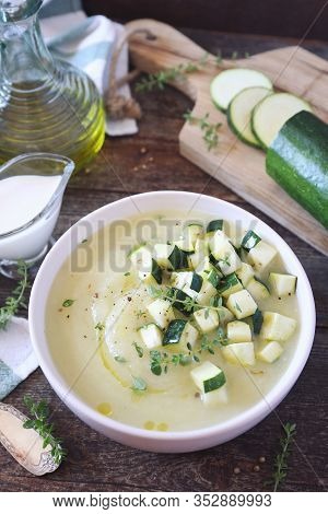 Zucchini Vegretable Cream Soup, Thyme And Olive Oil Dressing On Wooden Background. Rustic Style