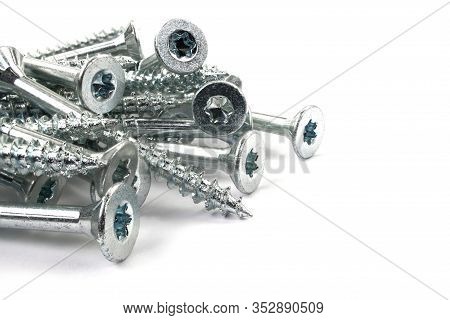 Torx Screws On White Background Close Up. Silver Screws For Wood, Chipboard Or Plywood With Torx Hea