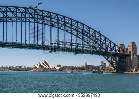 Sydney, Australia - December 11, 2009: Opera House Under Harbour Bridge, Metal Span, Bow And Stone A