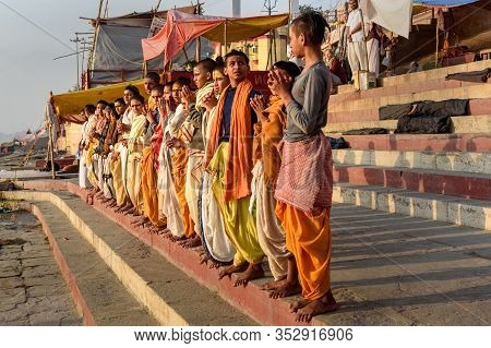 Varanasi, India - March 17, 2019: Young Hindu Priests On Ghats In Morning