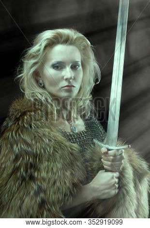 Valkyrie. Viking Fashioned Girl With Sword Portrait