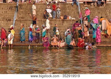 Varanasi, India - March 18, 2019: People Bathing In Water Holy Ganga River At Kedar Ghat In Morning
