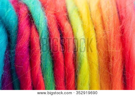 Yarn in spectrum of colors. Reel of colorful yarn. Shallow depth of field.