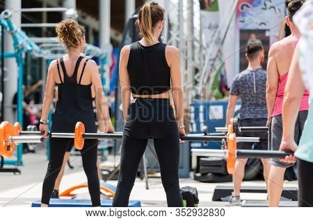 Girls Doing Weightlifting Exercises At Outdoor Gym With Step Platform: Fitness Workout.