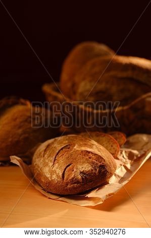 Different Buns Of Fresh Bread On A Brown Vintage Background. Freshly Baked Wheat Bread, Still Life W