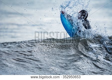 Long Shot Of Unrecognizable Surfer Breaking The Wave