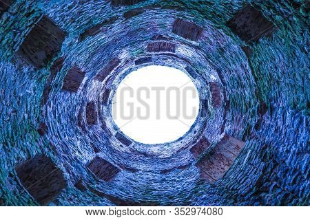 The Stone And Brick Fortress Or Castle Tower With Loopholes And Embrasure Without Roof From The Bott