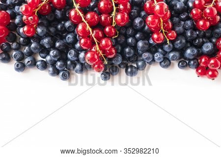 Mix Berries On A White Background. Ripe Blueberries And Red Currants On White Background. Top View. 