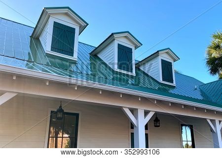 A Southern House Roof Line With 3 Gables And Green Shingles