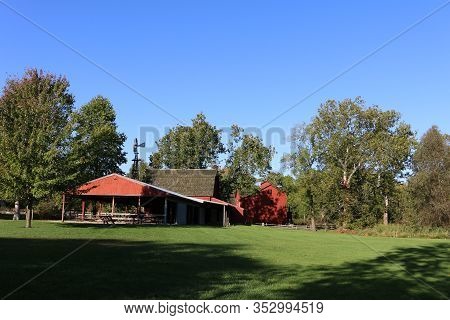 Midwest Farm Barn Buildings Next To A Meadow