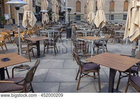 Empty Chairs And Tables At Restaurant Street Terrace Winter Day