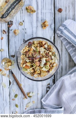 Messy Bowl Of Vegan Keto Granola Made With Pecans, Hazelnuts, Unsweetened Coconut, Sunflower Seeds, 